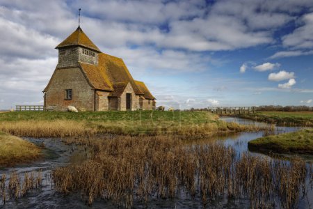 Photo for The lonely church on the marshland of St Thomas Becket Church in the lost village of Fairfield in Romney Marsh Kent England UK - Royalty Free Image