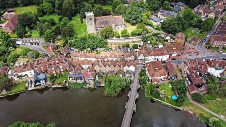 Photo for Drone view of the village of Aylesford village in Kent England UK with St Peter and Pauls church and the medieval stone bridge. - Royalty Free Image