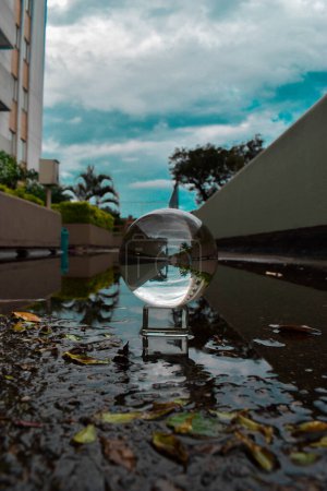 Photo for Reflection in wet floor due to rain and glass ball. Medellin, Antioquia, Colombia. - Royalty Free Image