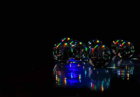 Photo for Small glass balls on holographic paper with sunlight. Medellin, Antioquia, Colombia. - Royalty Free Image