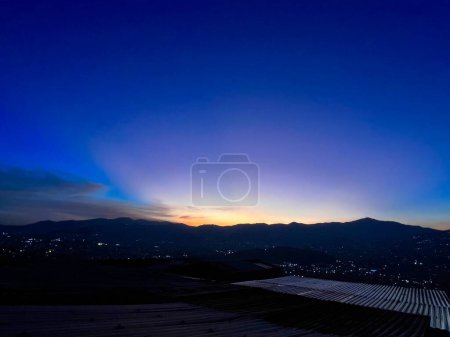 Bunter Sonnenuntergang mit blauem und orangefarbenem Himmel. Blick auf die Stadt Medellin.
