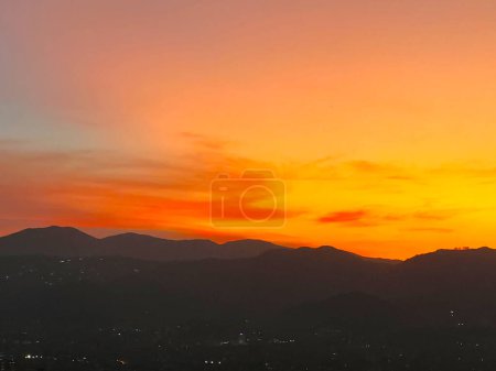 Beautiful sunset with orange sky and huge cloud seen from the Manrique neighborhood. Medellin, Antioquia, Colombia.