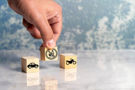 Photo for Person conceptualizes with wooden cubes the prohibition of drinking alcoholic beverages while driving a motor vehicle. High quality photo - Royalty Free Image