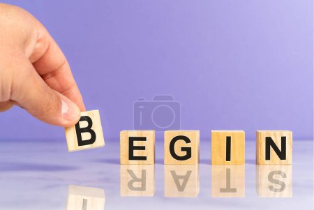 Photo for Hand placing wooden cubes with the word begin and start as a reflection. Professional growth mindset. High quality photo - Royalty Free Image
