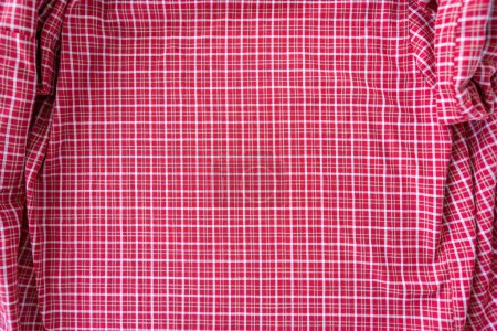 Background of red and white checkered fabric shirt. Fashion and textile concept. High quality photo