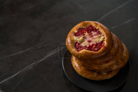 A kolach, from the Czech and Slovak is a type of sweet pastry that holds a portion of fruit surrounded by puffy yeast dough. 