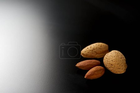 Almond fruit on black background