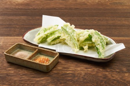  Winged beans tempura. Tempura is a Japanese cooking method that is a fried food similar to fritters.                             
