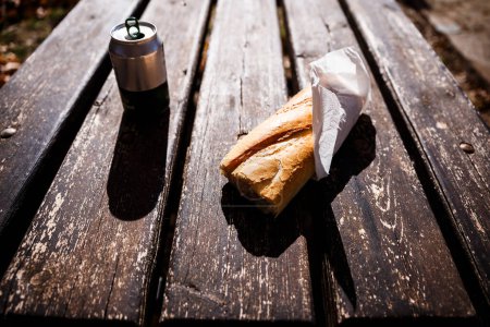 Photo for Sandwich and beer bottle on picnic table at Confrides - Royalty Free Image