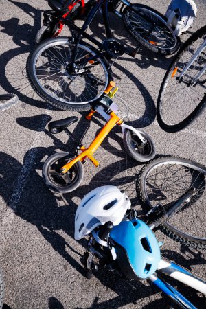 Photo for Bikes with helmets on the ground in Villajoyosa - Royalty Free Image
