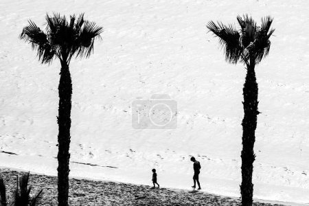 Photo for A father and son playing on the seashore in Villajoyosa - Royalty Free Image