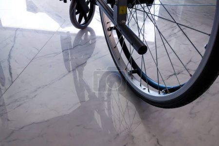 Photo for Wheelchair wheel reflected on the floor in Villajoyosa - Royalty Free Image