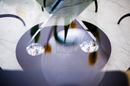 Photo for Reflections of yellow tulips on a glass table - Royalty Free Image