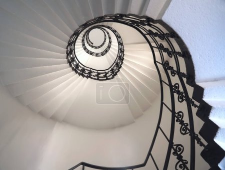 Spiral staircase Beautiful still life with black ornament railing top view