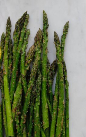 fresh green asparagus with spices on white background