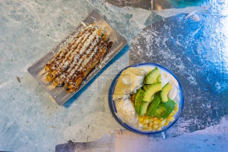 Ice mix is one of the refreshing drinks that can't be refused during hot weather, this dessert is called es teler with toppings of durian, corn, avocado and sliced coconut. and the accompaniment is fried banana cheese.