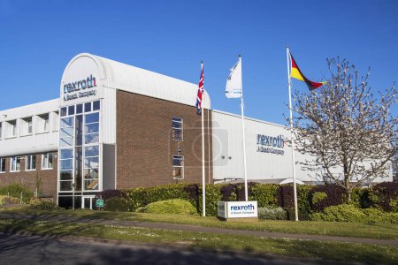 Photo for St Neots, UK - April 24th 2021: Flags flying outside the Rexroth Bosch factory. On a bright spring day, with blue sky's. High quality photo - Royalty Free Image
