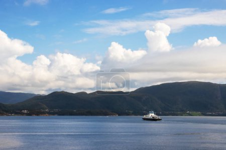Molde fjord in Norway with a small car ferry taking passengers from the island to the mainland. High quality photo