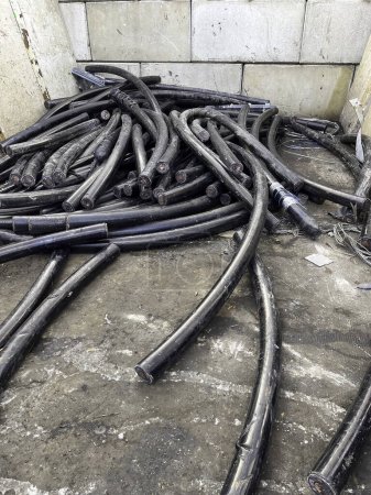 Portrait view of copper underground power cables waiting to be recycled in a scrap yard. High quality photo