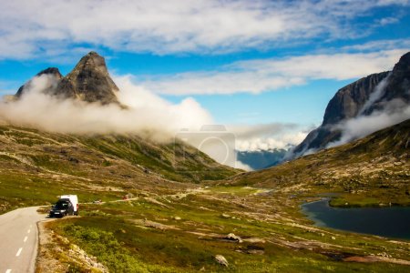 Vehicles in a layby in the valley overlooking Trollveggen Norway . High quality photo