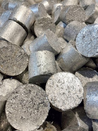 Briquettes of compressed Aluminium swarf ready to be re-melted. High quality photo