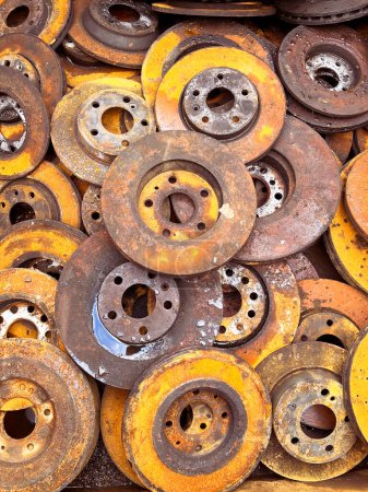 A heap of rusty iron car brake discs ready to be recycled. High quality photo
