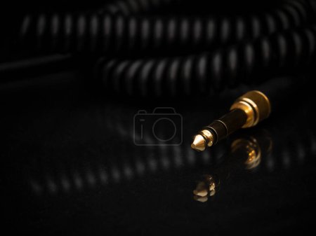 Photo for Gold-plated TRS connector for the analog audio signal are placed against a black background. Professional jack connector for sound equipment. Audiophile technologies concept. - Royalty Free Image