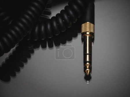 Photo for Gold-plated TRS connector for the analog audio signal are placed against a black background. Professional jack connector for sound equipment. Audiophile technologies concept. - Royalty Free Image