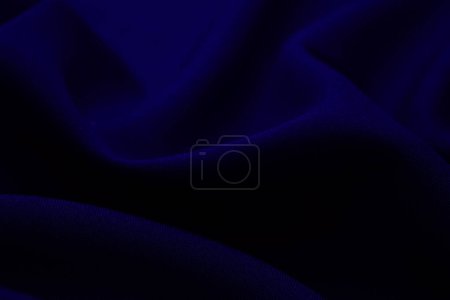 Photo for Texture of dark blue fabric closeup. Low key photo. Plexus threads. Clothing industry. Abstract background. Textile waves. - Royalty Free Image