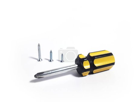 Yellow mini screwdriver and screws, isolated white background, made of iron and plastic