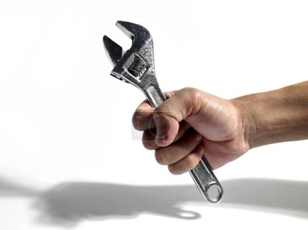 adjustable wrench being held by someone
