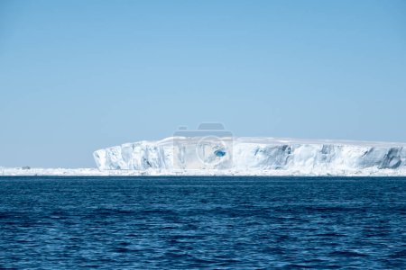 Photo for Large white tabular iceberg drifting south of the Antarctic Peninsula in the Weddell Sea in Southern Ocean, Antarctica - Royalty Free Image