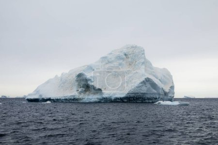 Photo for Melting iceberg covered with dust and soot spots, floating east of the Antarctic Peninsula, Antarctica - Royalty Free Image