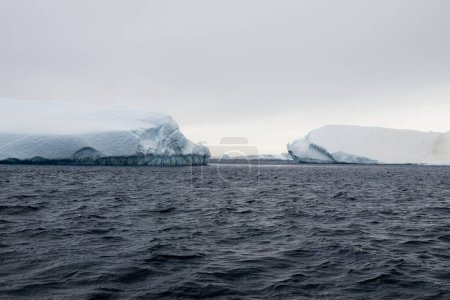 Photo for View of the safe passage between large drifting icebergs in Antarctica - Royalty Free Image