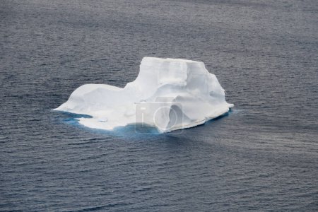 Photo for Bizarre-shaped iceberg melting in the Weddell Sea between the Vega Island and the Devil Island, Antarctica, view from the air - Royalty Free Image