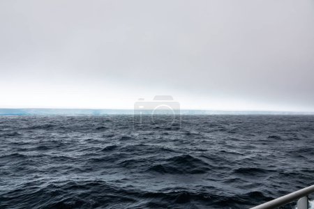 Photo for Cruise ship watching over the A23a iceberg, the world's largest iceberg covering 4,000 square kilometers - Royalty Free Image