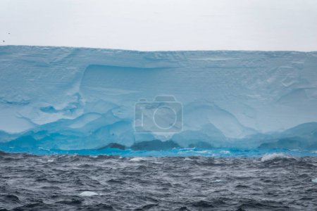 Photo for Blue reflections underneath the large tabular iceberg in the sea, Weddell Sea, Antarctica - Royalty Free Image