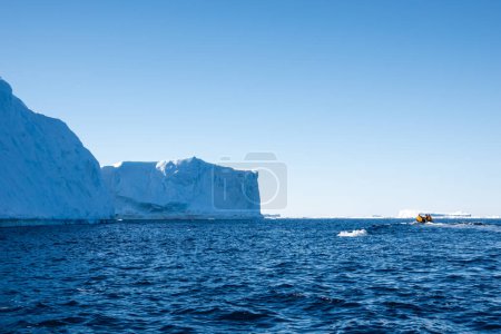 Photo for Tourists approaching large tabular iceberg on a zodiac boat, Weddell Sea, Antarctica - Royalty Free Image