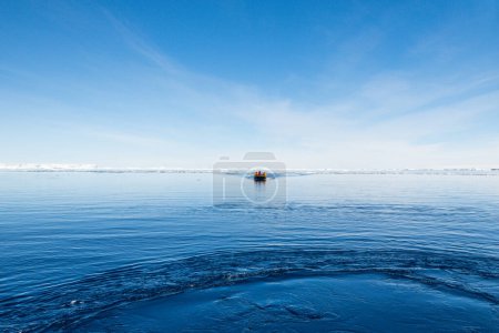 Photo for Inflatable zodiac boat cruising in the blue water of the Weddell Sea, Antarctica - Royalty Free Image
