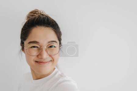 Photo for Asian Thai woman wear eyes glasses, taking selfie with happy smiling, isolated over white background wall. - Royalty Free Image