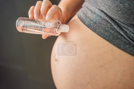 Photo for Turkiye, Antalya 02.02.2022: Woman holds Bio Oil, a nurturing choice for pregnant women. A soothing image of care and wellness during pregnancy. - Royalty Free Image