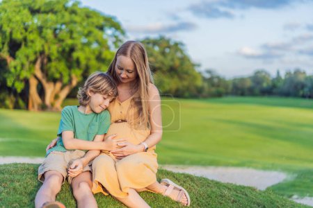 Photo for Heartwarming outdoor bonding as a pregnant mom and her son enjoy quality time together, savoring the beauty of nature and creating cherished moments. - Royalty Free Image