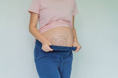 Photo for Chic maternity pants, comfy belly insert for expecting moms - stylish, practical, and perfect for the journey into motherhood. - Royalty Free Image