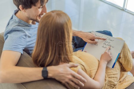 Expectant couple joyfully selects a name for their unborn son, savoring the special moment of choosing a meaningful identity for their growing family.