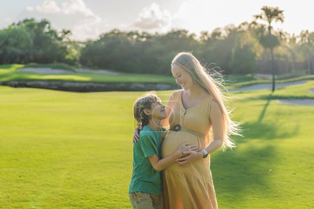 Heartwarming outdoor bonding as a pregnant mom and her son enjoy quality time together, savoring the beauty of nature and creating cherished moments.