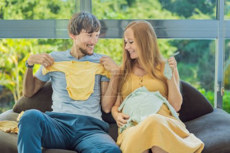 In a heartwarming scene, the future mom and dad hold their unborn babys clothes in their hands, savoring the joy of anticipation and shared excitement for their little ones arrival.