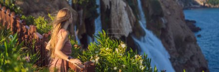 BANNER, LONG FORMAT Beautiful woman with long hair on the background of Duden waterfall in Antalya. Famous places of Turkey. Lower Duden Falls drop off a rocky cliff falling from about 40 m into the