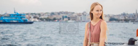 Photo for Woman tourist enjoying Galataport area view, cruise port of Istanbul newly opening in 2021, located in the shores of the Galata, Karakoy in Istanbul. BANNER, LONG FORMAT - Royalty Free Image