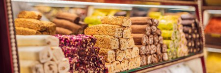 BANNER, LONG FORMAT Traditional oriental sweet pastry cookies, nuts, dried fruits, pastilles, marmalade, Turkish desert with sugar, honey and pistachio, in display at a street food market.