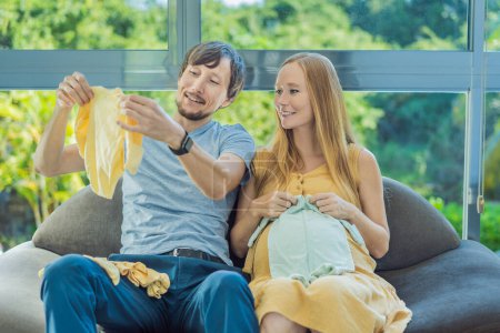 In a heartwarming scene, the future mom and dad hold their unborn babys clothes in their hands, savoring the joy of anticipation and shared excitement for their little ones arrival.